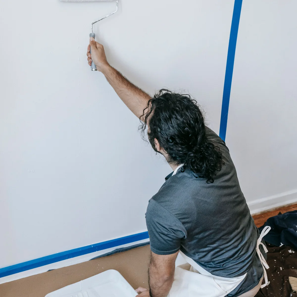 Interior wall being painted with a roller during renovation work